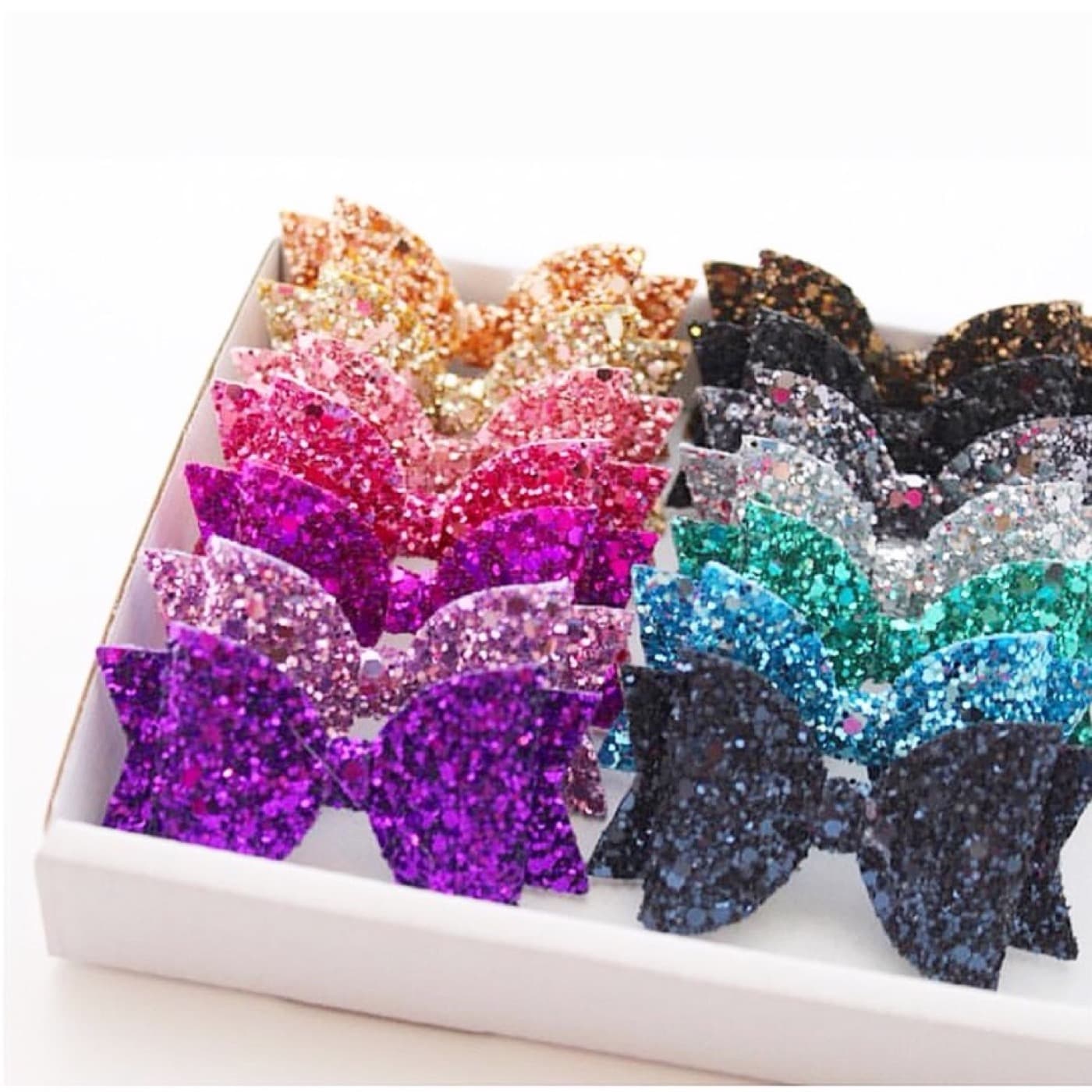 Glitter hairbows boxed up for an order, from Kerri's own Etsy shop